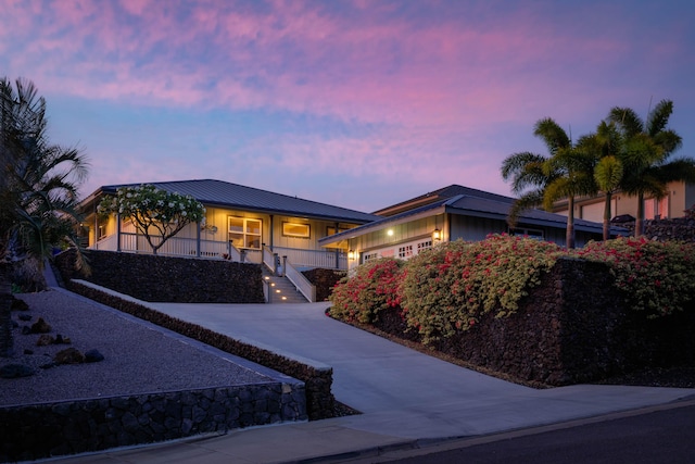 68-3609 Eleele St, Waikoloa, HI 96738 - single story home with a porch, a garage, stairway, a metal roof, and driveway