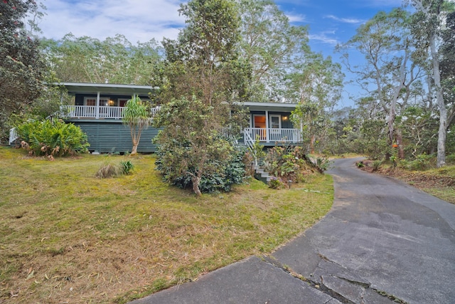 73-4310 Huehue St, Kailua-Kona, HI 96740 - view of front of property featuring covered porch, a front yard, stairs, and driveway