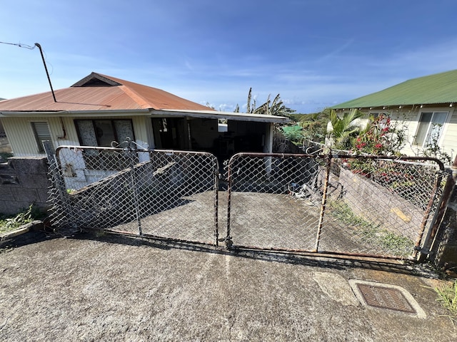 95-5581 Nahele St, Naalehu, HI 96772 - view of front of property featuring a fenced front yard, a gate, and concrete driveway