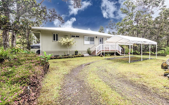 11-3082 Pa Alii St, Volcano, HI 96785 - view of front of home featuring stairs, driveway, a front lawn, a deck, and a metal roof