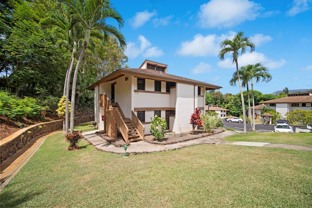 4701 Kawaihau Rd Unit B201, Kapaa, HI 96746 - view of front of property with stucco siding, a front lawn, and stairway