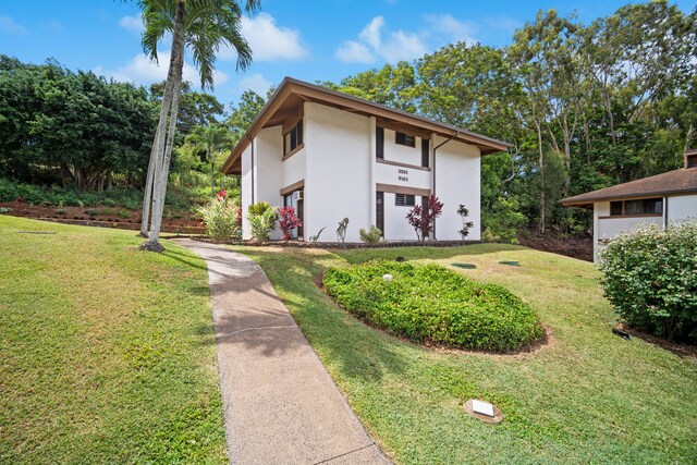 4701 Kawaihau Rd Unit B201, Kapaa, HI 96746 - view of front of property with stucco siding and a front lawn