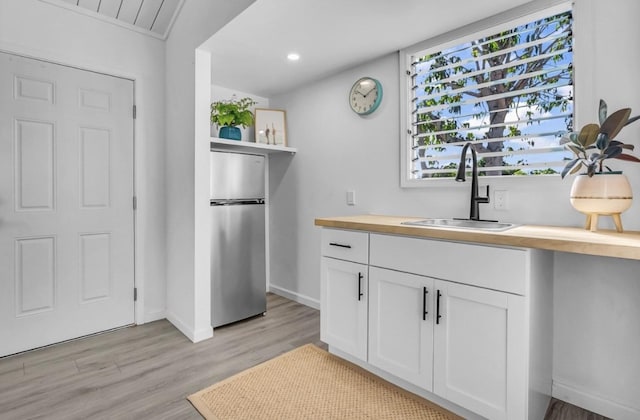 73-4338 Napoo Pl, Kailua-Kona, HI 96740 - kitchen featuring freestanding refrigerator, wood counters, light wood-style floors, white cabinets, and open shelves