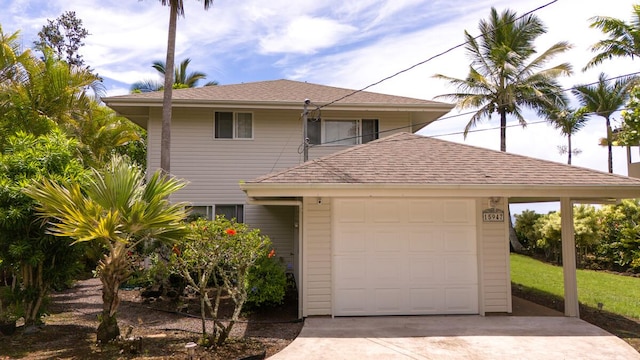 15-947 Paradise Ala Kai Dr, Keaau, HI 96749 - view of front of property with concrete driveway, a garage, and roof with shingles