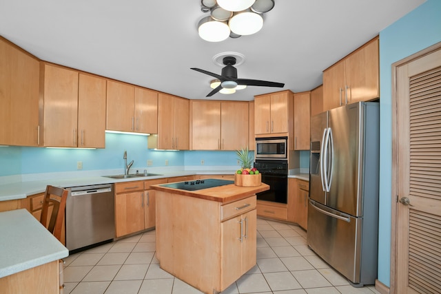 4491 Kikiaola Pl, Kekaha, HI 96752 - kitchen featuring black appliances, light brown cabinetry, and a center island