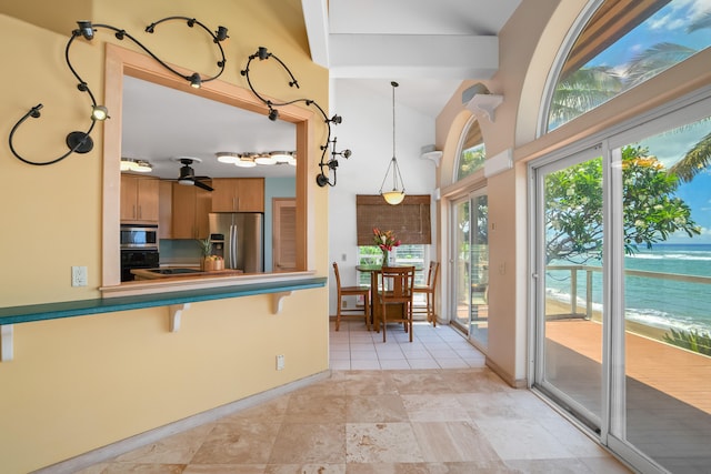 4491 Kikiaola Pl, Kekaha, HI 96752 - kitchen with black appliances, brown cabinets, ceiling fan, a breakfast bar, and a peninsula