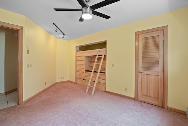 4491 Kikiaola Pl, Kekaha, HI 96752 - unfurnished bedroom featuring carpet flooring, multiple closets, track lighting, and ceiling fan