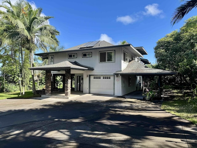 78-6694 Mamalahoa Hwy, Holualoa, HI 96740 - view of front of house featuring roof mounted solar panels, a garage, asphalt driveway, a porch, and roof with shingles