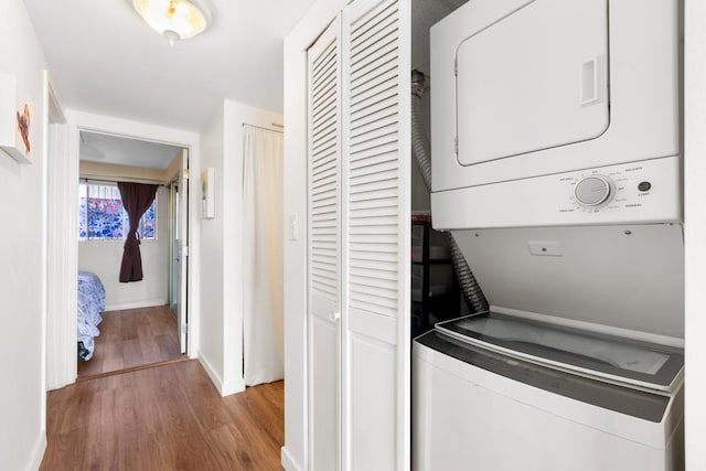 75-5719 Alii Dr Unit 314, Kailua-Kona, HI 96740 - washroom featuring stacked washer / dryer and wood finished floors