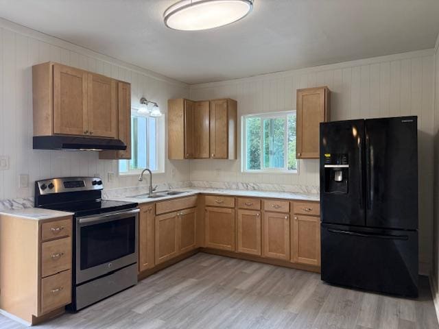 46-4180 Honokaa Waipio Rd, Honokaa, HI 96727 - kitchen with black fridge with ice dispenser, stainless steel electric range, under cabinet range hood, light wood-type flooring, and light countertops
