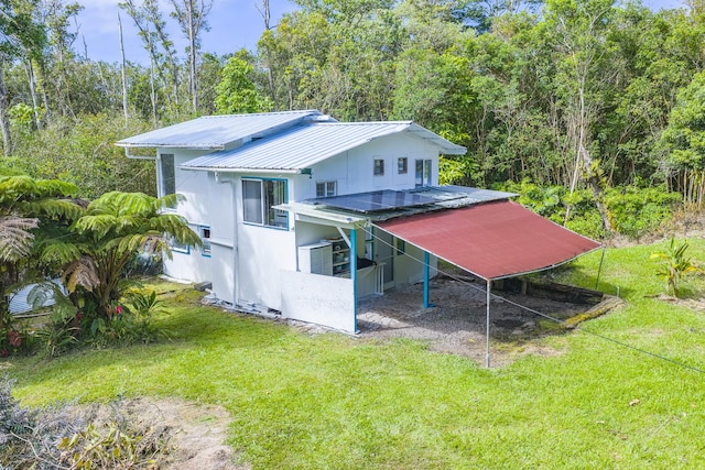 12-557 Hawaii St, Pahoa, HI 96778 - rear view of house featuring a yard, a metal roof, and driveway