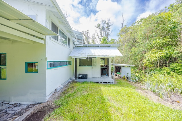 12-557 Hawaii St, Pahoa, HI 96778 - back of property featuring a yard and a metal roof