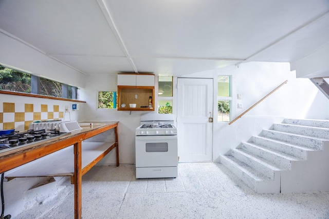 12-557 Hawaii St, Pahoa, HI 96778 - kitchen featuring white gas range, dark speckled floor, and gas cooktop