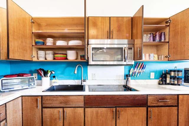 28-238 Akaka Falls Rd, Honomu, HI 96728 - kitchen with stainless steel microwave, open shelves, black electric stovetop, and light countertops