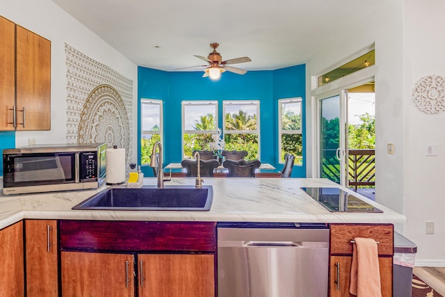 28-238 Akaka Falls Rd, Honomu, HI 96728 - kitchen featuring stainless steel appliances, a ceiling fan, light countertops, and healthy amount of natural light