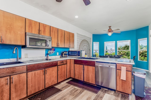 28-238 Akaka Falls Rd, Honomu, HI 96728 - kitchen with stainless steel appliances, ceiling fan, light countertops, light wood-style floors, and brown cabinetry