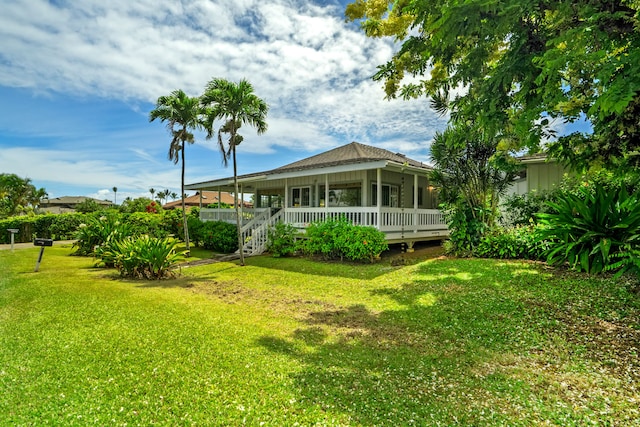 3795 Kelii Pl, Princeville, HI 96722 - back of property with a lawn and a porch