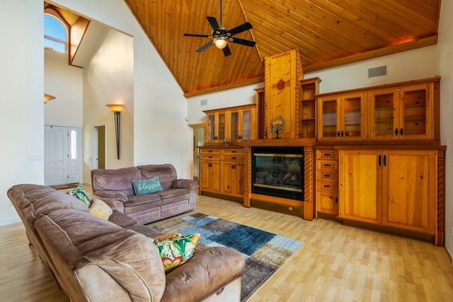 6201-B Kawaiihau Rd Unit B, Kapaa, HI 96746 - living room with high vaulted ceiling, wood ceiling, light wood finished floors, ceiling fan, and a glass covered fireplace