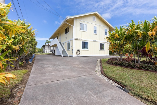 55-548 Hawi Rd, Hawi, HI 96719 - view of front of property with stairs, board and batten siding, and concrete driveway