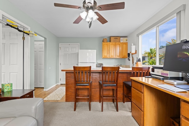 55-548 Hawi Rd, Hawi, HI 96719 - kitchen featuring freestanding refrigerator, light countertops, an office area, ceiling fan, and a kitchen breakfast bar