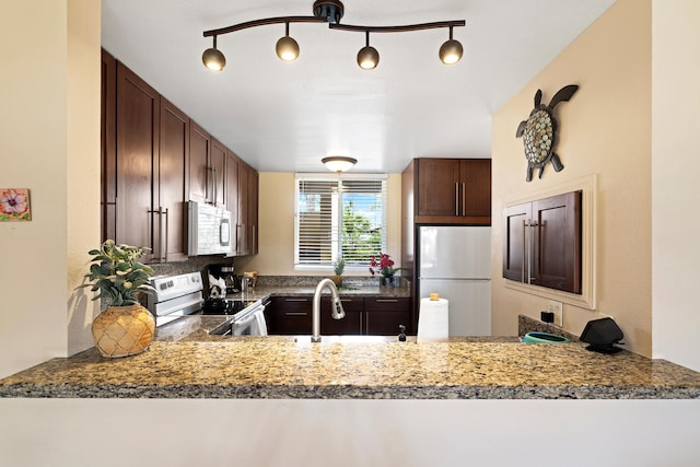 78-6800 Alii Dr Unit 7202, Kailua-Kona, HI 96740 - kitchen with white appliances, a peninsula, and dark brown cabinets