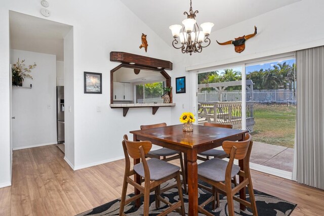 68-1760 Nawili Pl, Waikoloa, HI 96738 - dining room with a chandelier, light wood finished floors, and vaulted ceiling