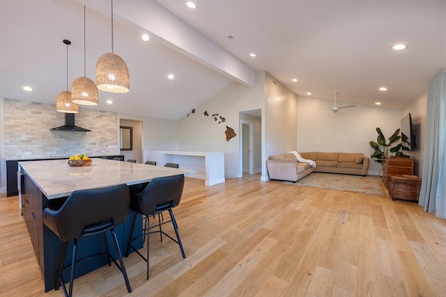 68-1785 Niu Haohao Pl, Waikoloa, HI 96738 - kitchen featuring light wood-type flooring, a spacious island, a breakfast bar area, pendant lighting, and recessed lighting