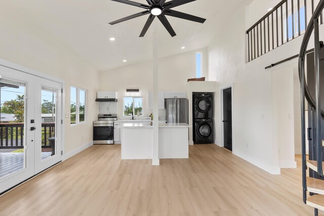 16-2078 Mauna Kea Dr, Pahoa, HI 96778 - kitchen featuring stainless steel appliances, stacked washer / drying machine, light countertops, high vaulted ceiling, and a ceiling fan