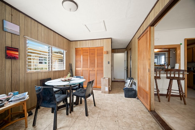 7786 Ulili Rd, Kekaha, HI 96752 - dining room featuring wooden walls, crown molding, and light tile patterned floors
