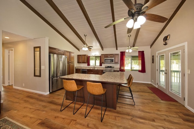 15-2736 Ahi St, Pahoa, HI 96778 - kitchen with stainless steel appliances, high vaulted ceiling, light countertops, a wooden ceiling with exposed beams, and a kitchen breakfast bar