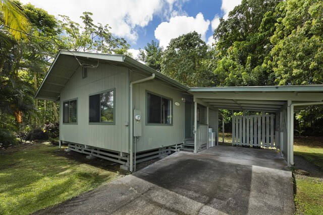 15-2736 Ahi St, Pahoa, HI 96778 - view of front of property with driveway, a carport, a front yard, and entry steps