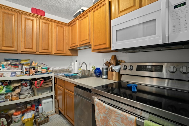 3-3400 Kuhio Hwy Unit B101, Lihue, HI 96766 - kitchen with stainless steel appliances, brown cabinets, light countertops, and a textured ceiling