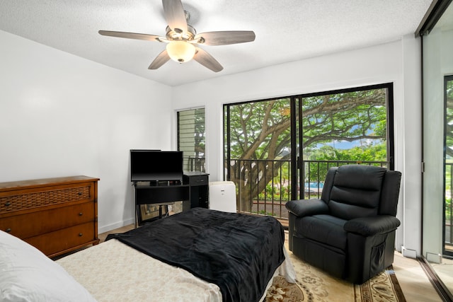 3-3400 Kuhio Hwy Unit B101, Lihue, HI 96766 - bedroom with a textured ceiling, ceiling fan, and light wood finished floors