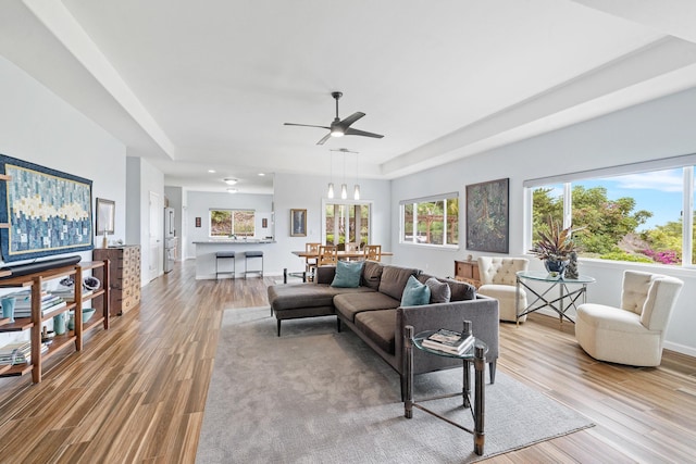 68-2182 Laakea Way, Waikoloa, HI 96738 - living area featuring light wood-type flooring, a ceiling fan, and a raised ceiling