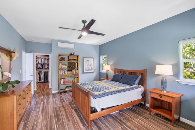 68-2182 Laakea Way, Waikoloa, HI 96738 - bedroom with an AC wall unit, wood tiled floors, a walk in closet, ceiling fan, and a closet