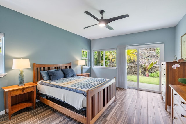 68-2182 Laakea Way, Waikoloa, HI 96738 - bedroom featuring wood tiled floors, access to exterior, multiple windows, and a ceiling fan