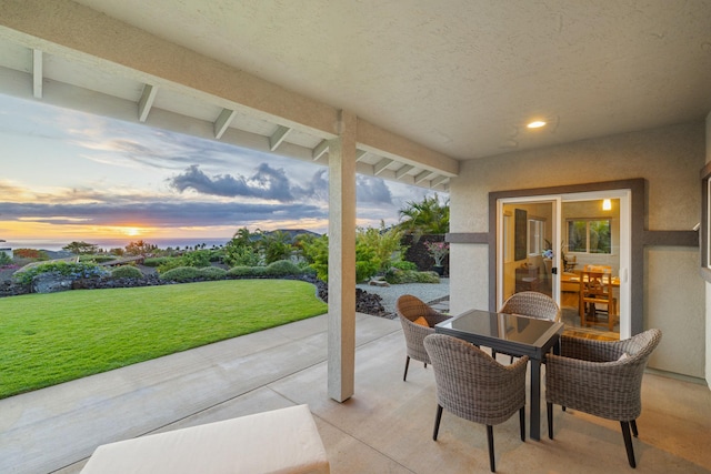 68-2182 Laakea Way, Waikoloa, HI 96738 - patio terrace at dusk with a patio area, a lawn, and outdoor dining space