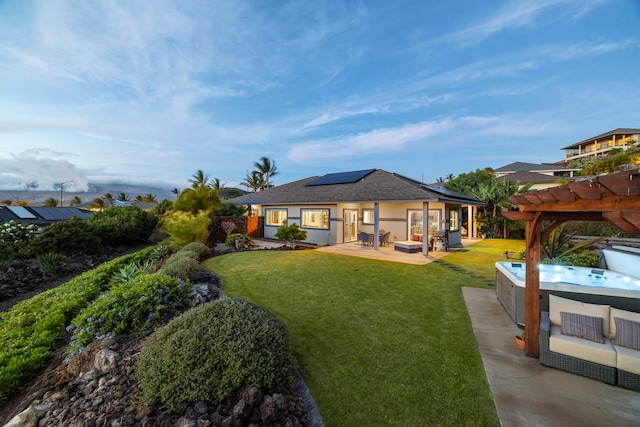 68-2182 Laakea Way, Waikoloa, HI 96738 - rear view of house with roof mounted solar panels, a pergola, a yard, a hot tub, and a patio area