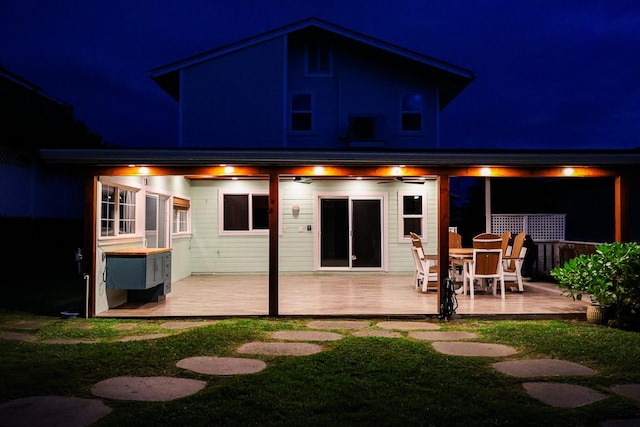 76-206 Kealoha St Unit 2A, Kailua-Kona, HI 96740 - back of house at night with a deck and a yard