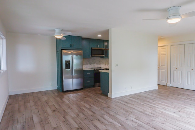 76-206 Kealoha St Unit 2A, Kailua-Kona, HI 96740 - kitchen featuring stainless steel appliances, ceiling fan, light countertops, backsplash, and light wood finished floors
