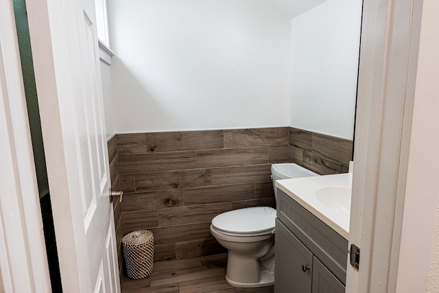 76-206 Kealoha St Unit 2A, Kailua-Kona, HI 96740 - half bathroom with vanity, wainscoting, tile walls, and wood finished floors