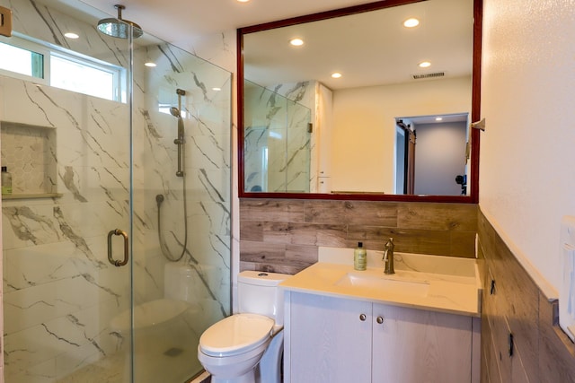 76-206 Kealoha St Unit 2A, Kailua-Kona, HI 96740 - bathroom featuring a marble finish shower, recessed lighting, vanity, wainscoting, and tile walls