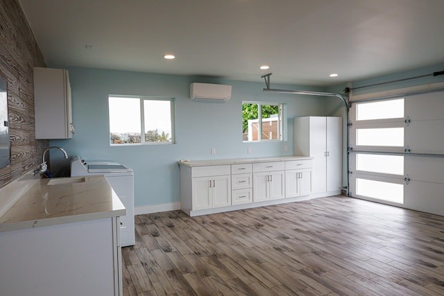 76-206 Kealoha St Unit 2A, Kailua-Kona, HI 96740 - laundry area with an AC wall unit, light wood-type flooring, and recessed lighting
