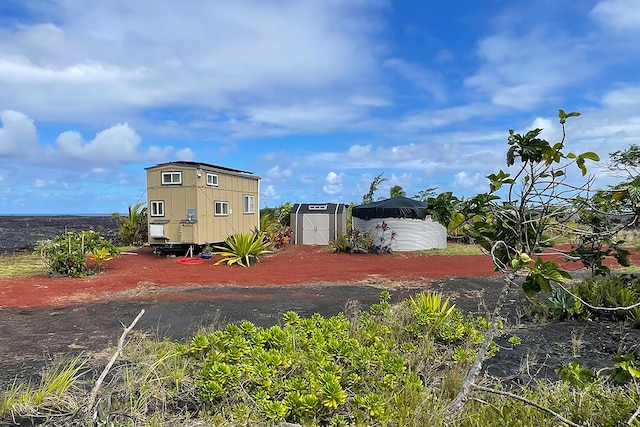 1 Piilani Rd, Pahoa, HI 96778 - rear view of property with a storage shed