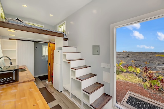 1 Piilani Rd, Pahoa, HI 96778 - stairs with wood finished floors, recessed lighting, a barn door, and electric panel