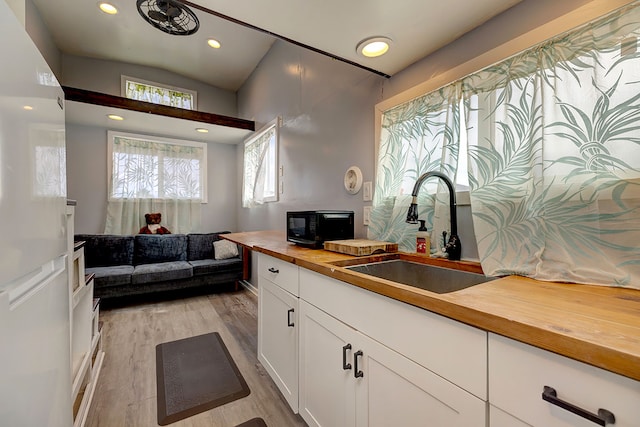 1 Piilani Rd, Pahoa, HI 96778 - kitchen featuring butcher block counters, light wood-type flooring, white cabinets, recessed lighting, and open floor plan