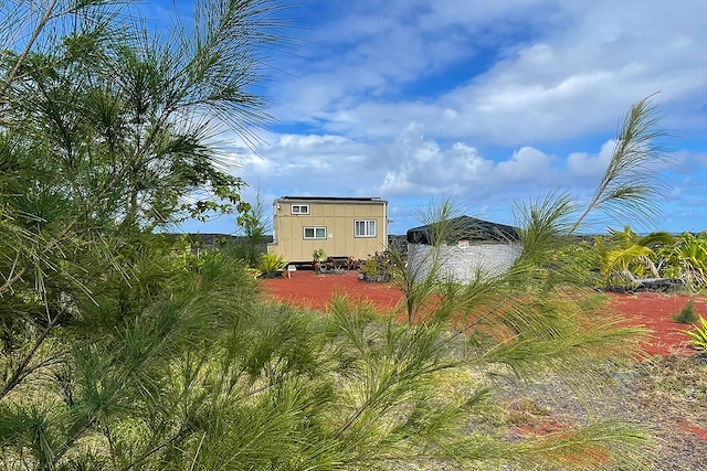 1 Piilani Rd, Pahoa, HI 96778 - view of side of home featuring a storage unit