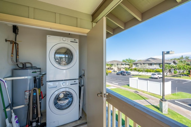 68-3932 Ehu Kai Loop Unit 3403, Waikoloa, HI 96738 - laundry area featuring stacked washer / drying machine, strapped water heater, and a residential view