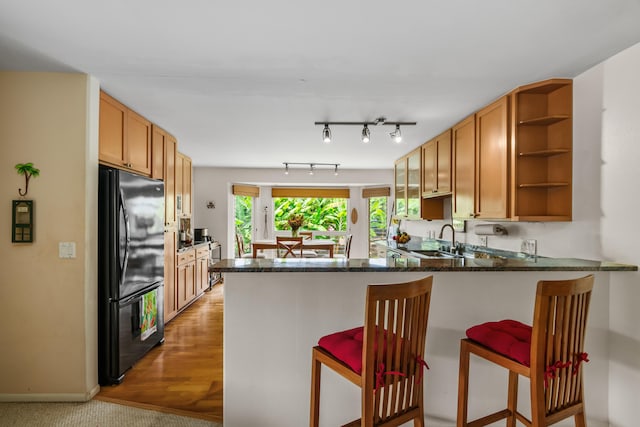 2364-C Hulemalu Rd, Lihue, HI 96766 - kitchen with freestanding refrigerator, open shelves, a peninsula, a kitchen bar, and dark stone countertops