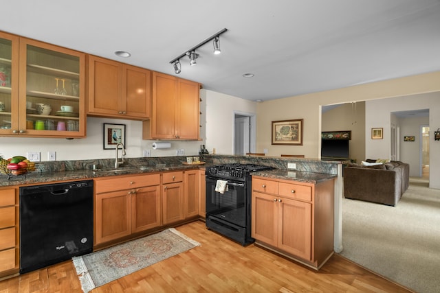 2364-C Hulemalu Rd, Lihue, HI 96766 - kitchen featuring black appliances, a peninsula, light wood-style flooring, open floor plan, and glass insert cabinets